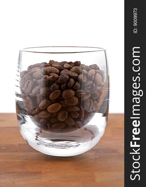 Coffea Beans In Glass On Wooden Table