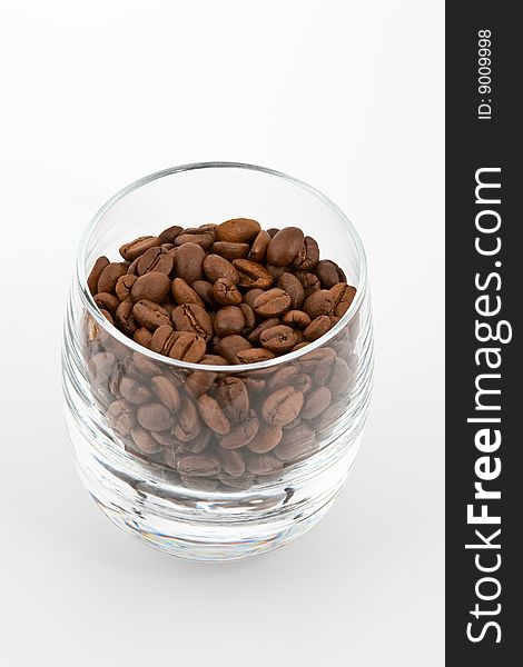 Coffea beans in glass on white background