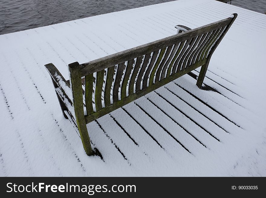 Snow-covered simple wooden bench in Amstelveen, the Netherlands. Snow-covered simple wooden bench in Amstelveen, the Netherlands.