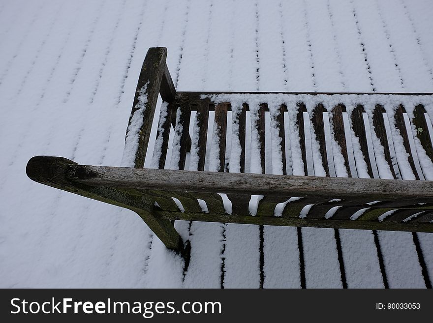 Snow-covered simple wooden bench in Amstelveen, the Netherlands. Snow-covered simple wooden bench in Amstelveen, the Netherlands.