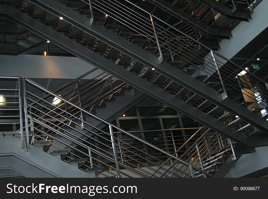 A view in a building with stairways and metal rails. A view in a building with stairways and metal rails.