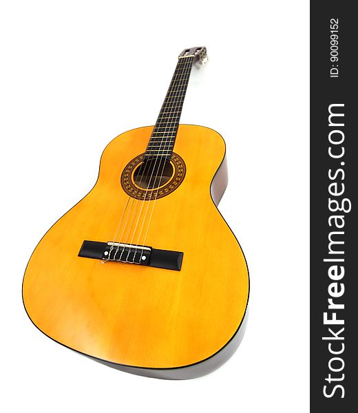 Classic wooden acoustic guitar isolated on white.