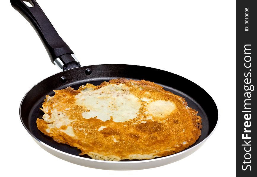 Pancake cooking in a pan isolated on white background