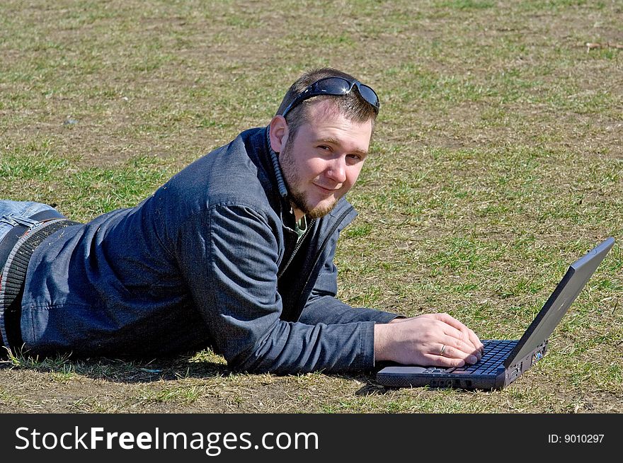 Man on meadow with laptop. Man on meadow with laptop