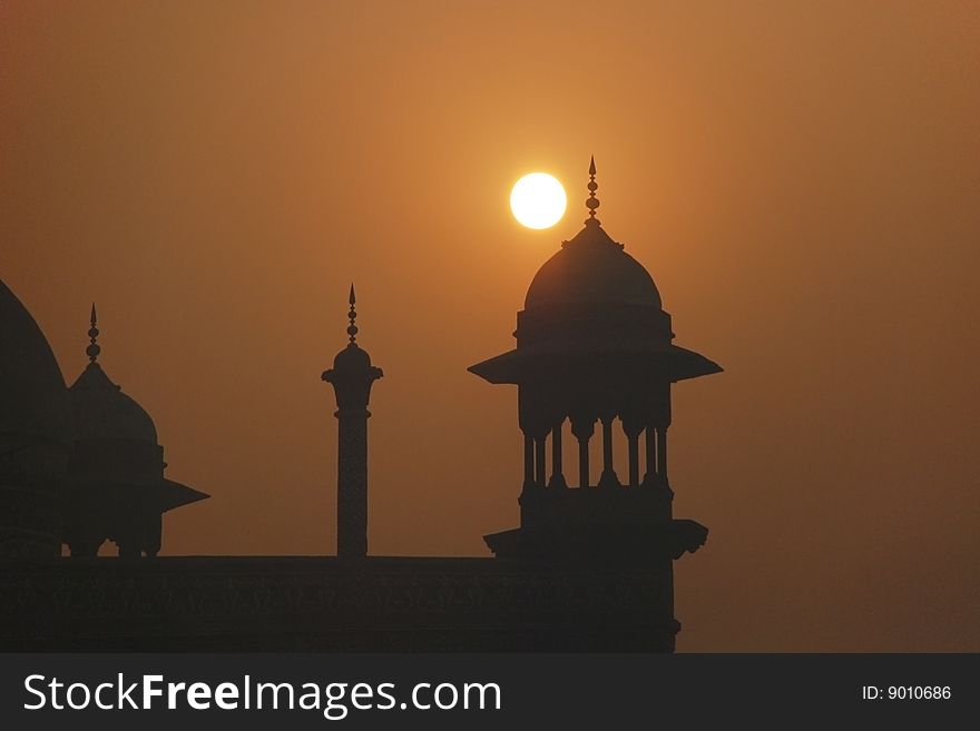 Silhouette of mosque tower at sunset