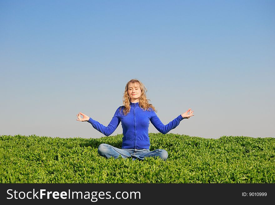 The young girl meditates in a spring field. The young girl meditates in a spring field