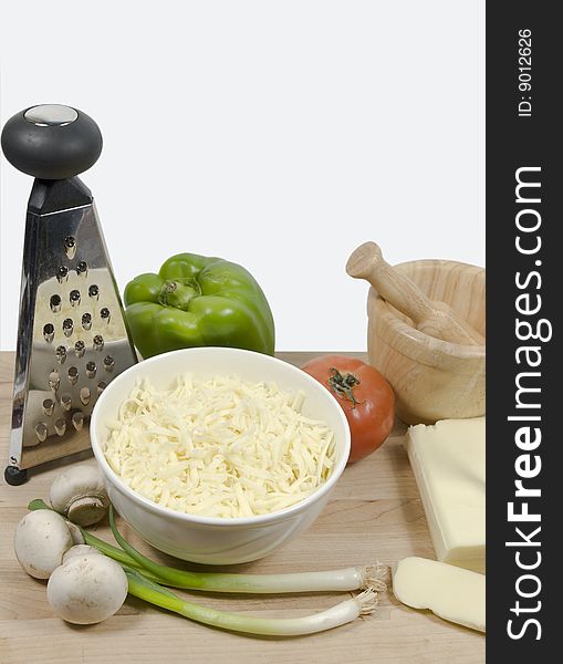 Pizza ingredient on a wooden cutting board with isolated white background. Pizza ingredient on a wooden cutting board with isolated white background