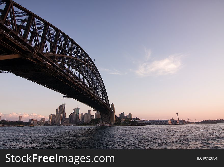 Sydney Harbour Bridge just before sunset. Tilted perspective and blue toned.