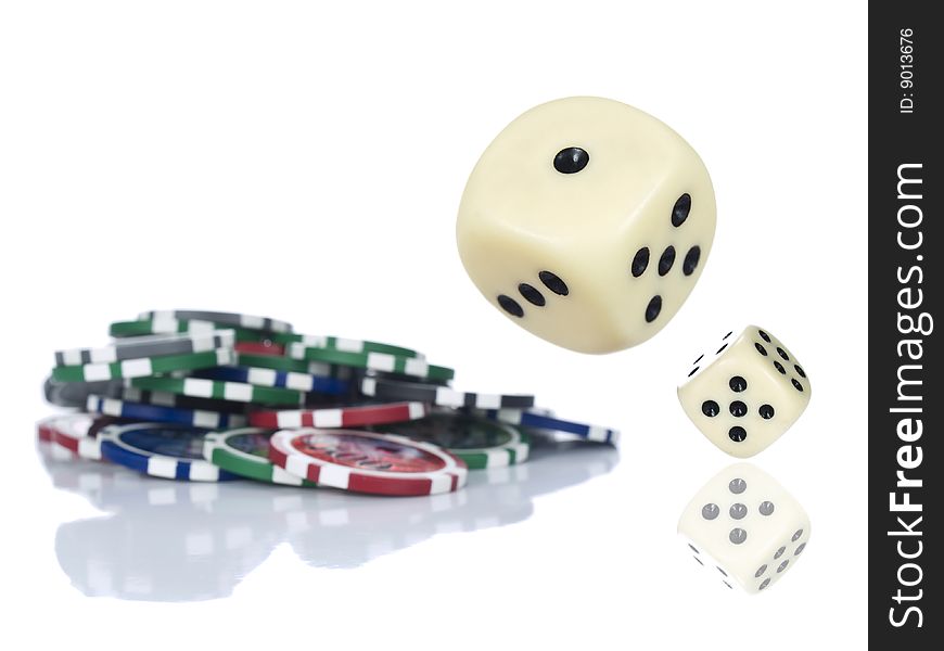 Two dices rolling beside some gambling chips. Isolated on white. Two dices rolling beside some gambling chips. Isolated on white.