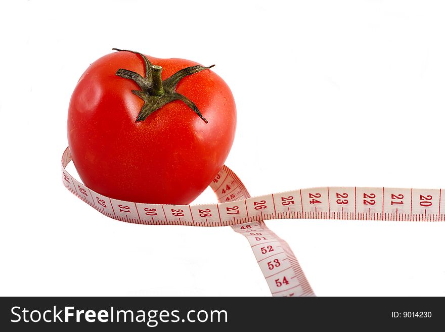 A tomato wrapped up by measuring tape. A tomato wrapped up by measuring tape