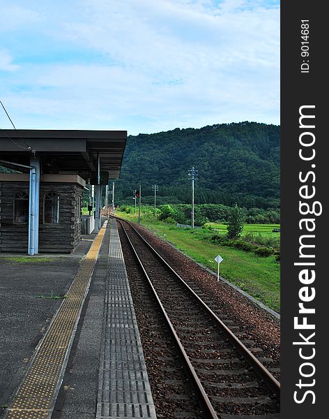 Railway track leading to a station in the countryside. Railway track leading to a station in the countryside