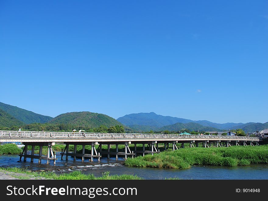 Long wooden bridge across a river