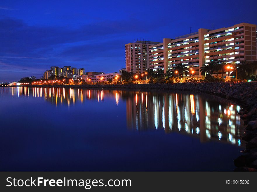 Serene and calm night view of residential building with reflections in a lake