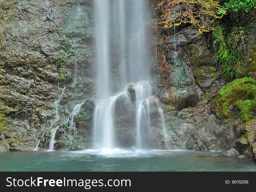 Majestic waterfall falling on rocks