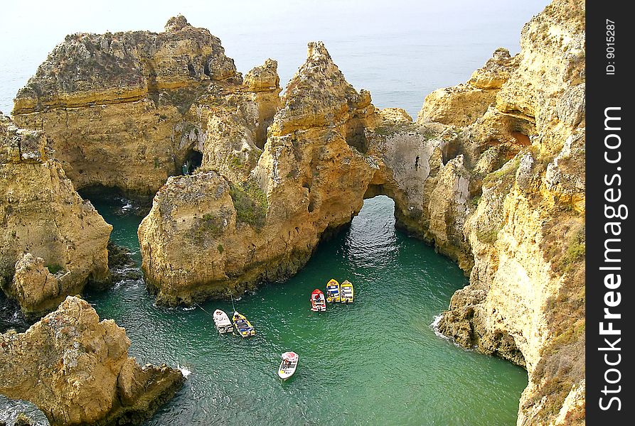 Portugal fishing boats on water of Atlantic ocean in a grotto near Lagos, Algarve. Portugal fishing boats on water of Atlantic ocean in a grotto near Lagos, Algarve