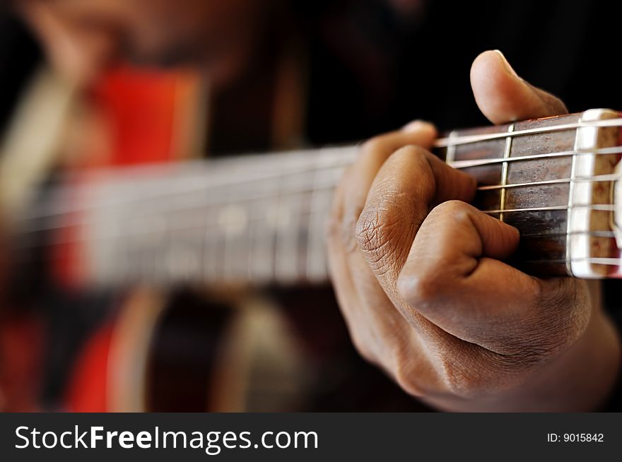 Closeup of hand playing guitar