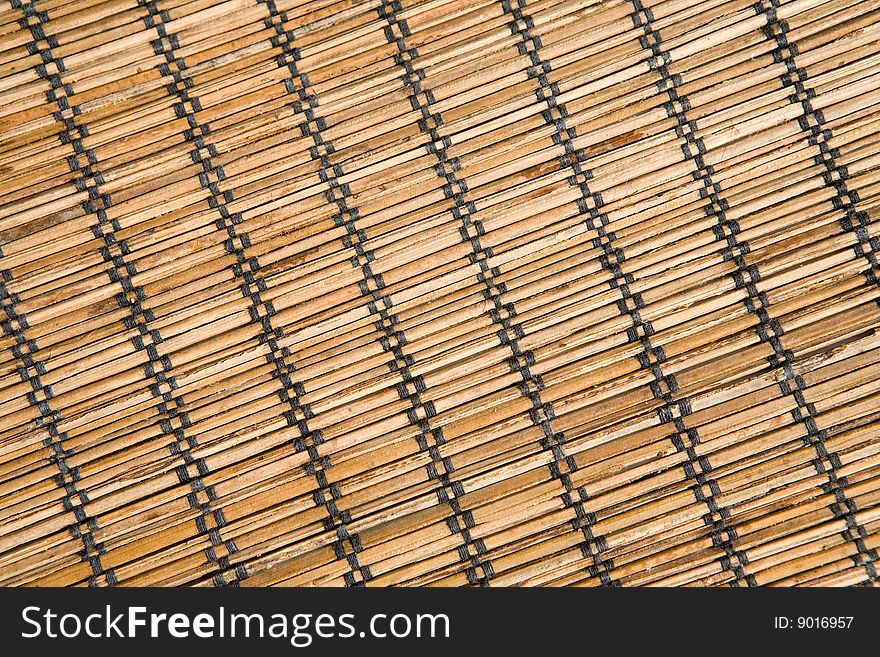 Bamboo mat with black threads texture in diagonal. Bamboo mat with black threads texture in diagonal