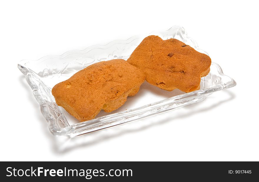 Two cakes on a glass plate isolated