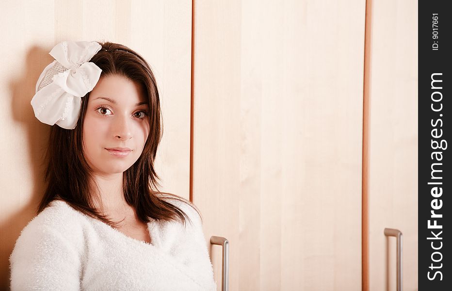 Pretty young girl with a bow in dark hair