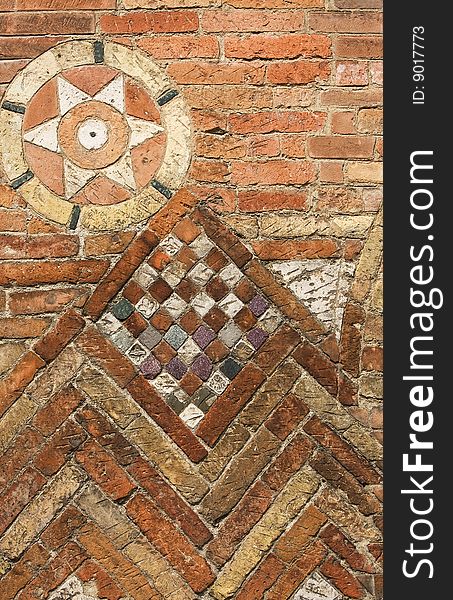 Brick wall with decorative mosaic
