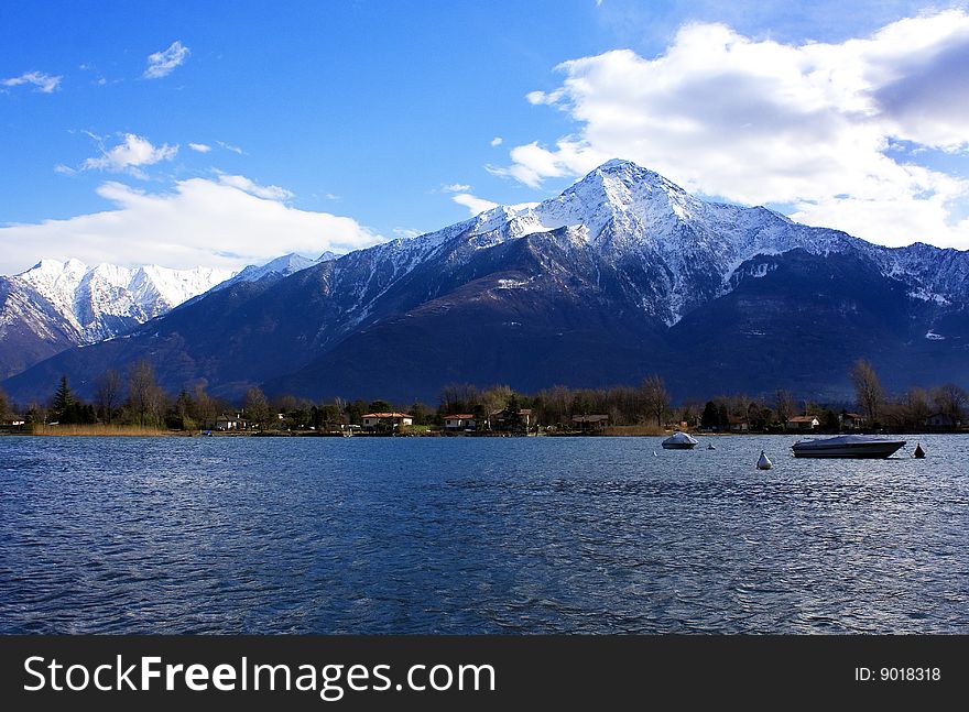 the lake by boat and snow-capped mountains