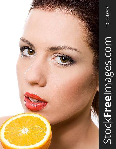Closeup portrait of girl with half of orange over white. Closeup portrait of girl with half of orange over white
