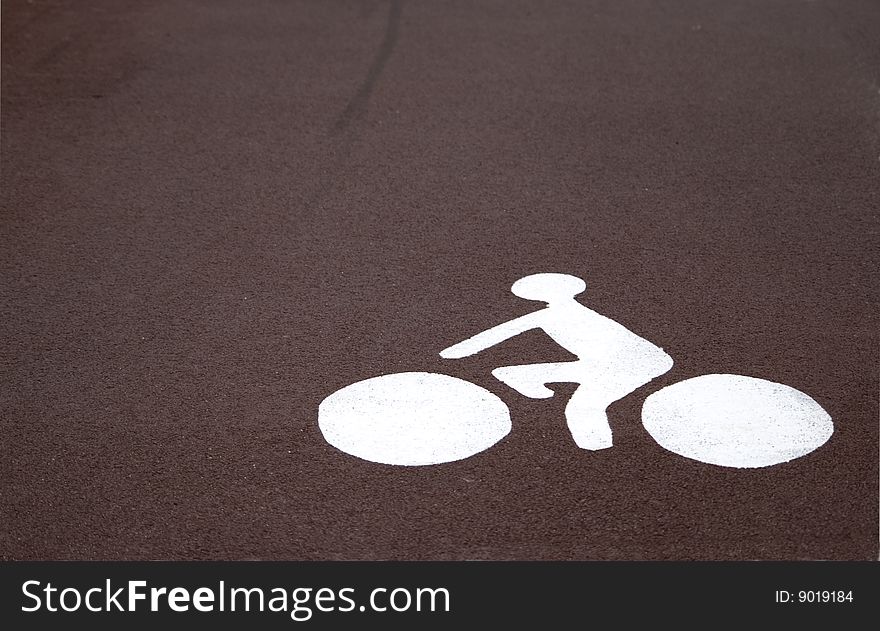 A cycle path side. White sign on dark red background. A cycle path side. White sign on dark red background.