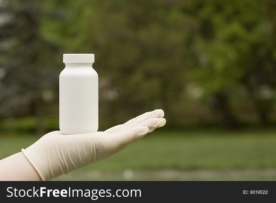 A white box on hand. The white surface waiting for your product label. Tree's in the background.