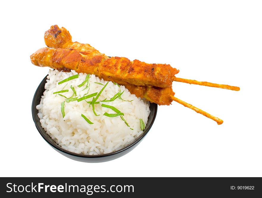 Two Chicken satay sticks with rice over white background