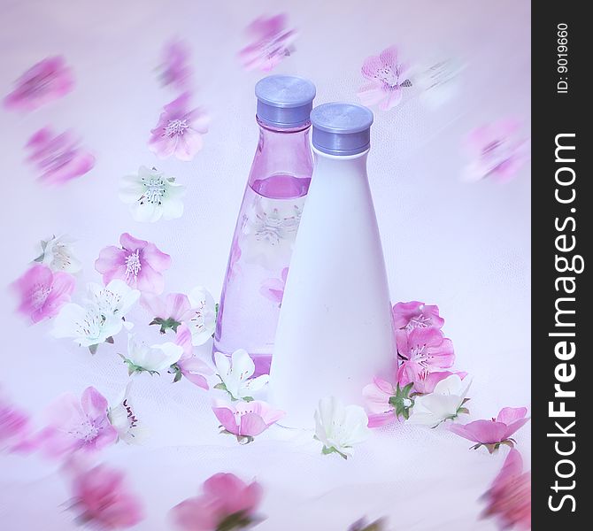 Cosmetic bottles with pink and white flowers. Cosmetic bottles with pink and white flowers