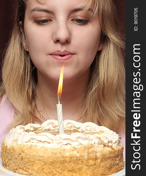 Girl blows on a candle