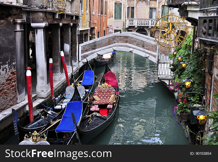 The water streets of Venice are canals which are navigated by gondolas and other small boats. During daylight hours the canals, bridges, and streets of Venice are full of tourists eager to experience the romance of this great travel destination. As night engulfs the town, tourists enjoy some fine dining at one of the many restaurants, leaving the waterways and streets quiet. The gondola is a traditional, flat-bottomed Venetian rowing boat, well suited to the conditions of the Venetian Lagoon. For centuries gondolas were once the chief means of transportation and most common watercraft within Venice. In modern times the iconic boats still have a role in public transport in the city, serving as ferries over the Grand Canal. They are also used in special regattas &#x28;rowing races&#x29; held amongst gondoliers. Their main role, however, is to carry tourists on rides throughout the canals. Gondolas are hand made using 8 different types of wood &#x28;fir, oak, cherry, walnut, elm, mahogany, larch and lime&#x29; and are composed of 280 pieces. The oars are made of beech wood. The left side of the gondola is longer than the right side. This asymmetry causes the gondola to resist the tendency to turn toward the left at the forward stroke. Venetian masks are a centuries-old tradition of Venice. The masks are typically worn during the Carnival of Venice, but have been used on many other occasions in the past, usually as a device for hiding the wearer&#x27;s identity and social status. The mask would permit the wearer to act more freely in cases where he or she wanted to interact with other members of the society outside the bounds of identity and everyday convention. It was thus useful for a variety of purposes, some of them illicit or criminal, others just personal, such as romantic encounters. The water streets of Venice are canals which are navigated by gondolas and other small boats. During daylight hours the canals, bridges, and streets of Venice are full of tourists eager to experience the romance of this great travel destination. As night engulfs the town, tourists enjoy some fine dining at one of the many restaurants, leaving the waterways and streets quiet. The gondola is a traditional, flat-bottomed Venetian rowing boat, well suited to the conditions of the Venetian Lagoon. For centuries gondolas were once the chief means of transportation and most common watercraft within Venice. In modern times the iconic boats still have a role in public transport in the city, serving as ferries over the Grand Canal. They are also used in special regattas &#x28;rowing races&#x29; held amongst gondoliers. Their main role, however, is to carry tourists on rides throughout the canals. Gondolas are hand made using 8 different types of wood &#x28;fir, oak, cherry, walnut, elm, mahogany, larch and lime&#x29; and are composed of 280 pieces. The oars are made of beech wood. The left side of the gondola is longer than the right side. This asymmetry causes the gondola to resist the tendency to turn toward the left at the forward stroke. Venetian masks are a centuries-old tradition of Venice. The masks are typically worn during the Carnival of Venice, but have been used on many other occasions in the past, usually as a device for hiding the wearer&#x27;s identity and social status. The mask would permit the wearer to act more freely in cases where he or she wanted to interact with other members of the society outside the bounds of identity and everyday convention. It was thus useful for a variety of purposes, some of them illicit or criminal, others just personal, such as romantic encounters.