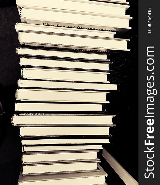 Stack of books against black.