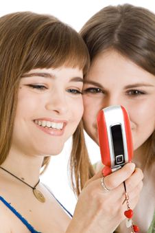 Two Pretty Girls Reading SMS On Mobile Phone Royalty Free Stock Photography