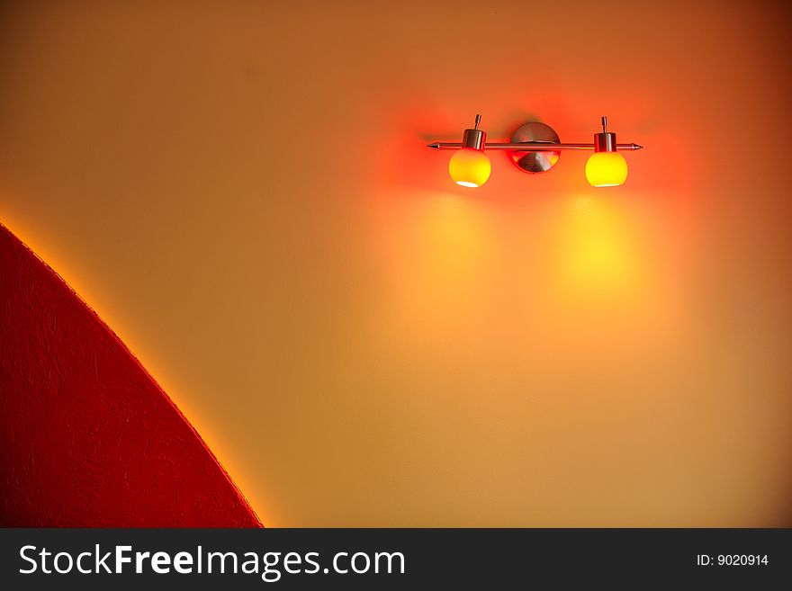 Red lamp on yellow wall