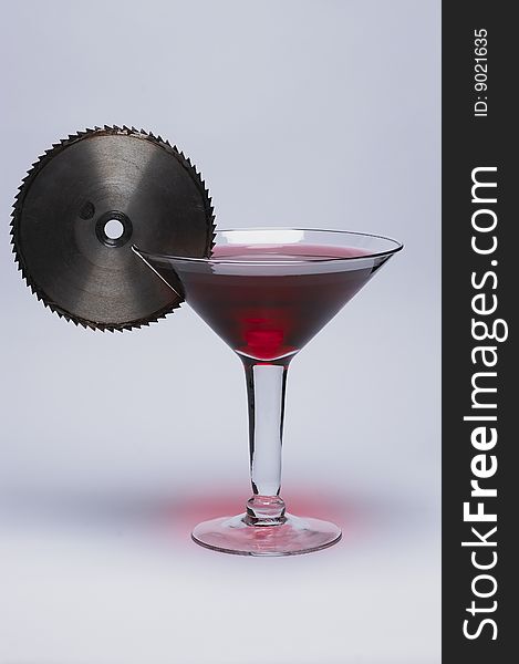 Oversize martini glass with sawblade garnish. Oversize martini glass with sawblade garnish