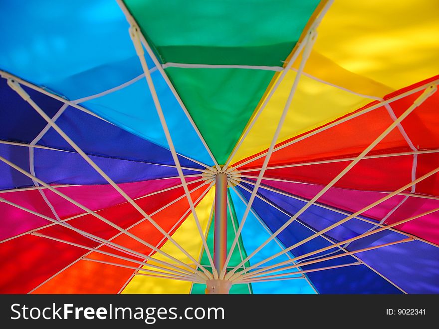 Abstract image of the underside of a colorful umbrella, showing the spokes. Abstract image of the underside of a colorful umbrella, showing the spokes