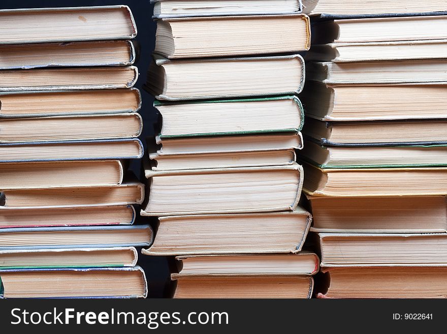 Three piles old books on black background. Three piles old books on black background