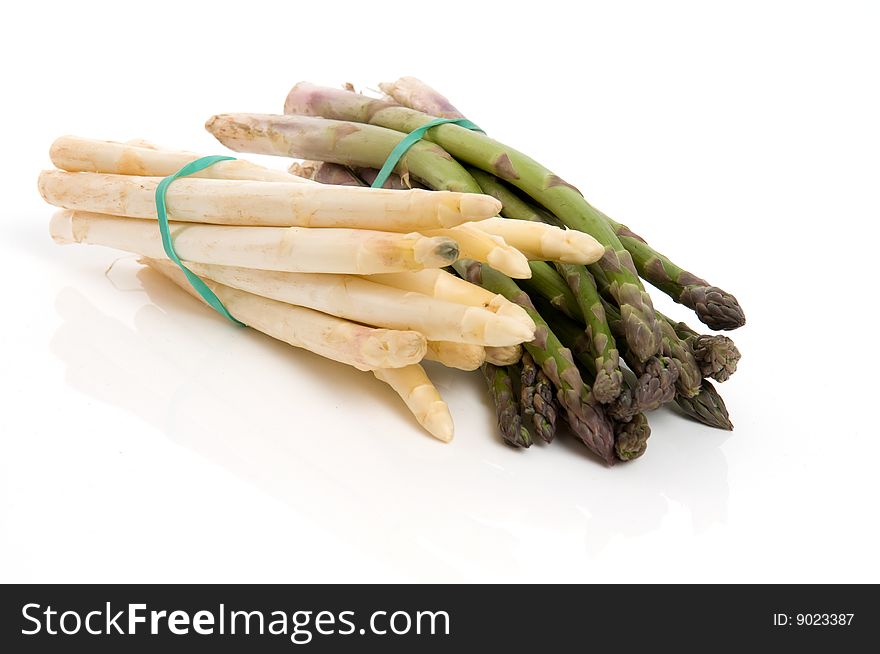 White and green asparagus in front of white. White and green asparagus in front of white