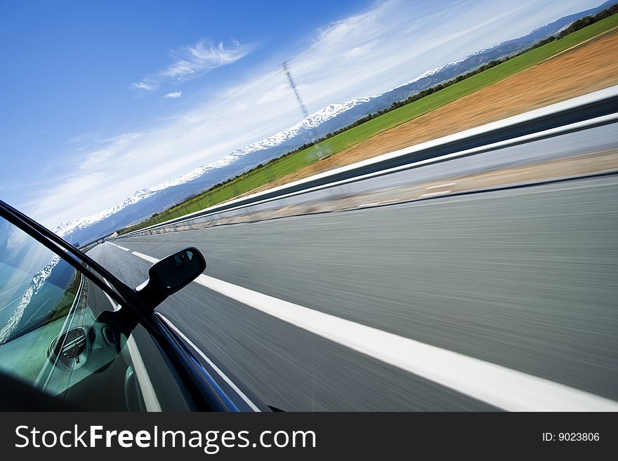 Driving at high speed under blue sky. Angled point of view. Driving at high speed under blue sky. Angled point of view