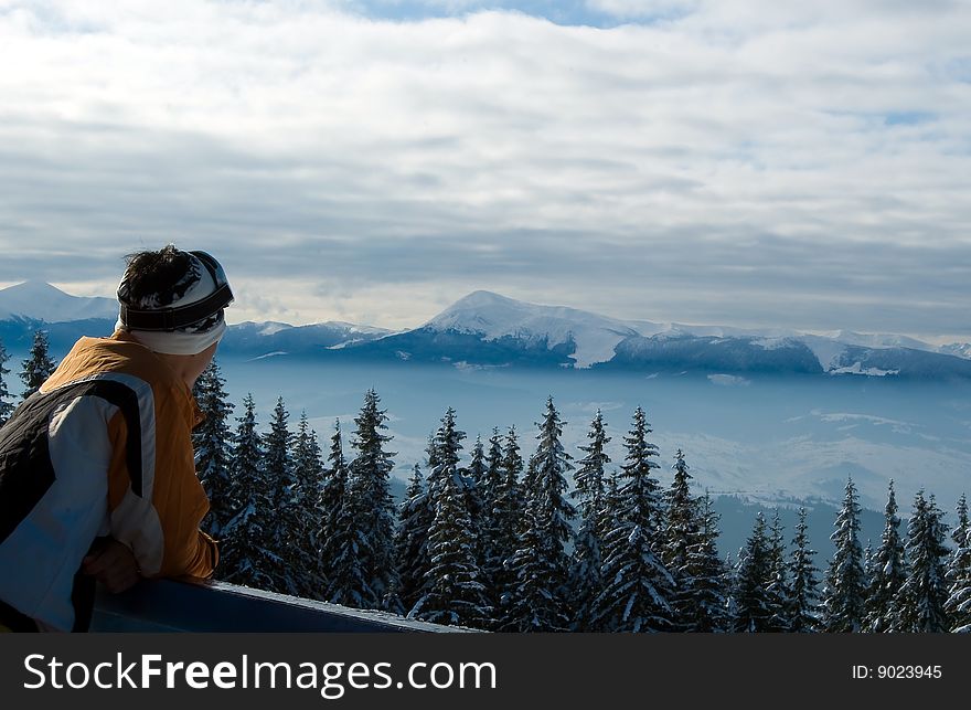 Skier observing the landscape from the top of the