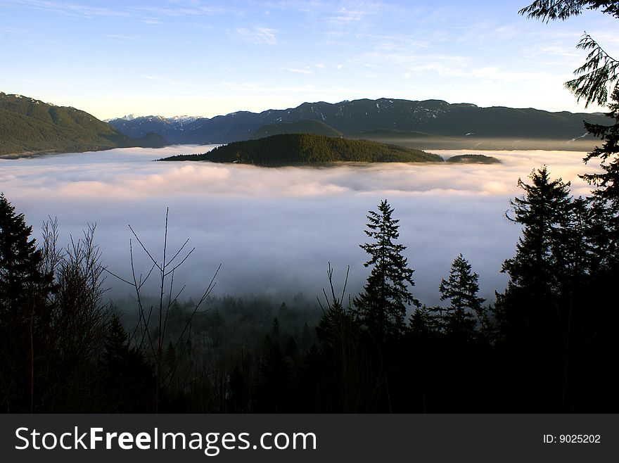 A view from Burnaby Mountain towards the Burrard Inlet and Indian Arm covered in clouds near Vancouver, Canada. A view from Burnaby Mountain towards the Burrard Inlet and Indian Arm covered in clouds near Vancouver, Canada.