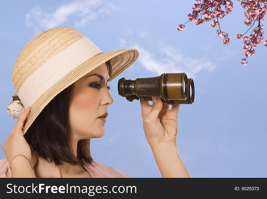 Young woman looking through binocular. isolated on white background