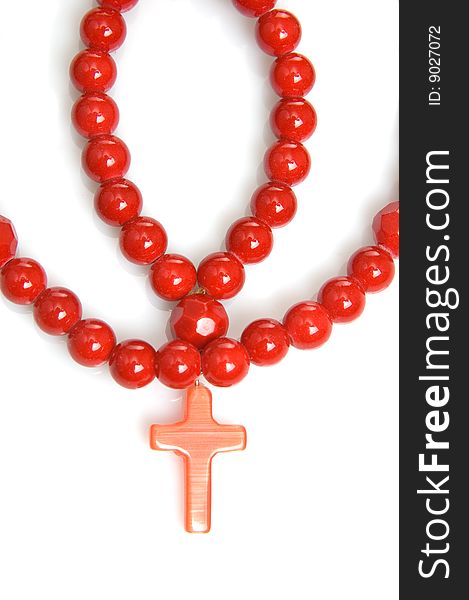 Red coral beads on a white background