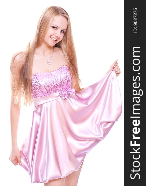 Woman in a pink dress posing on a white background