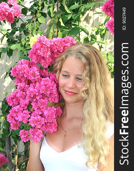 Pretty blond freckled girl with pink flowers. Pretty blond freckled girl with pink flowers.
