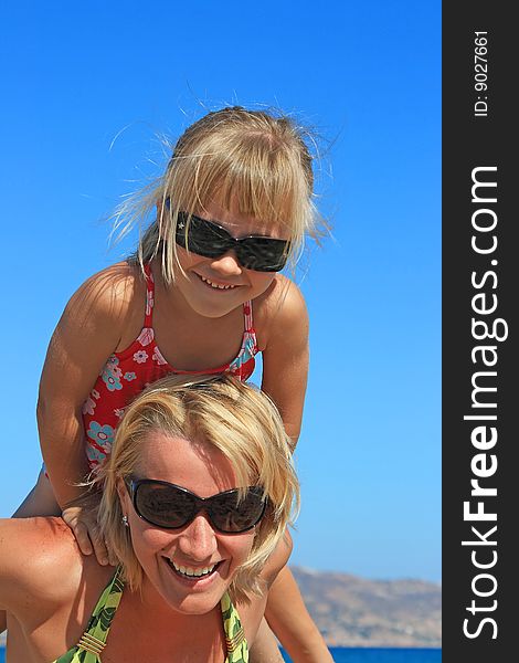 Happy mum with a daughter have a rest on the sea