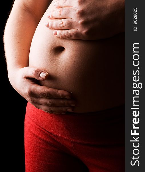 Young Pregnant Woman holding her Belly