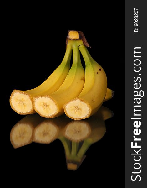 Still life mature cut bananas on black background with clipping path