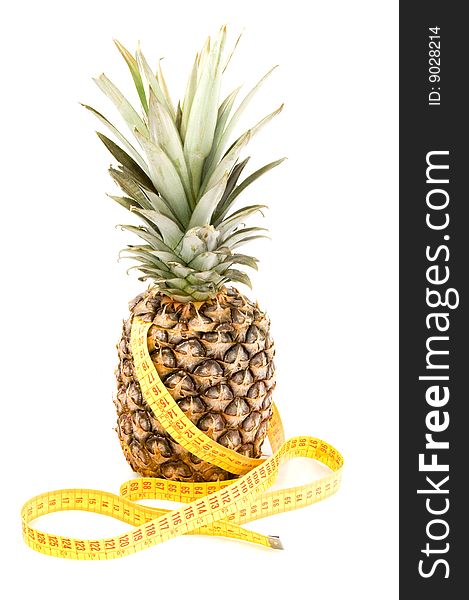 Fresh pineapple with tape measure isolated on white background